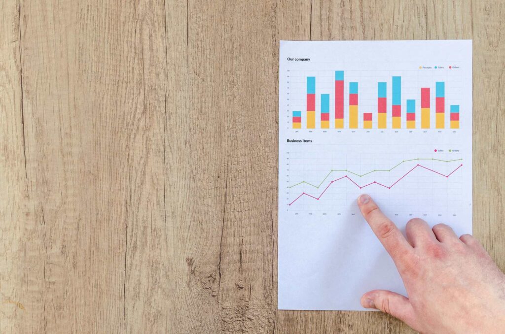 Person Pointing Paper Line Graph
