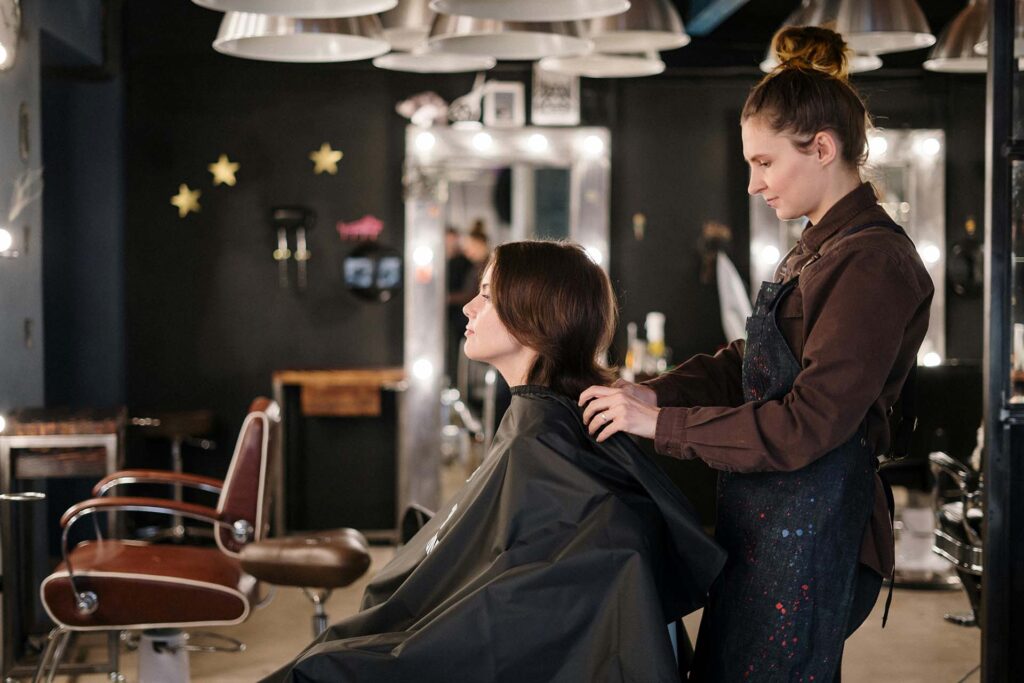 A hairdresser working on a client