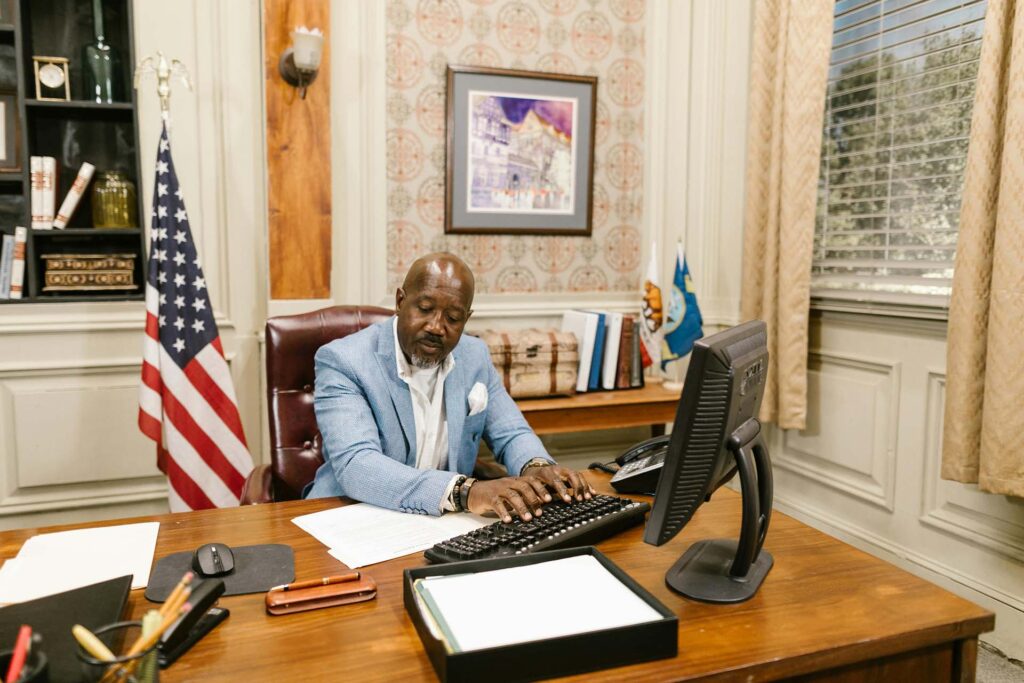  A lawyer in a blue suit using a computer in an office