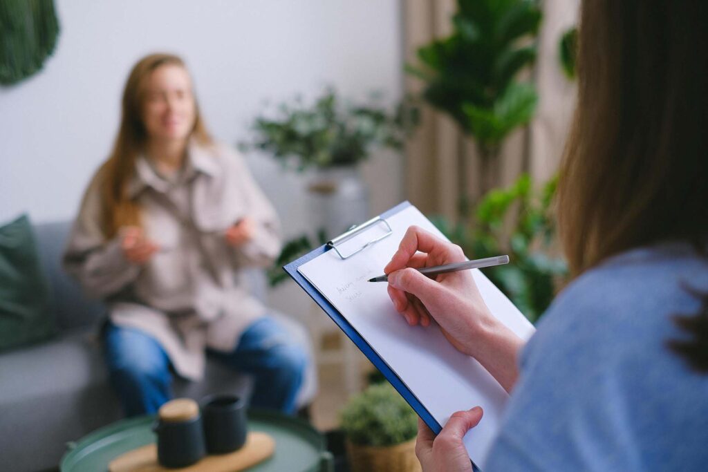 A therapist taking notes during an appointment